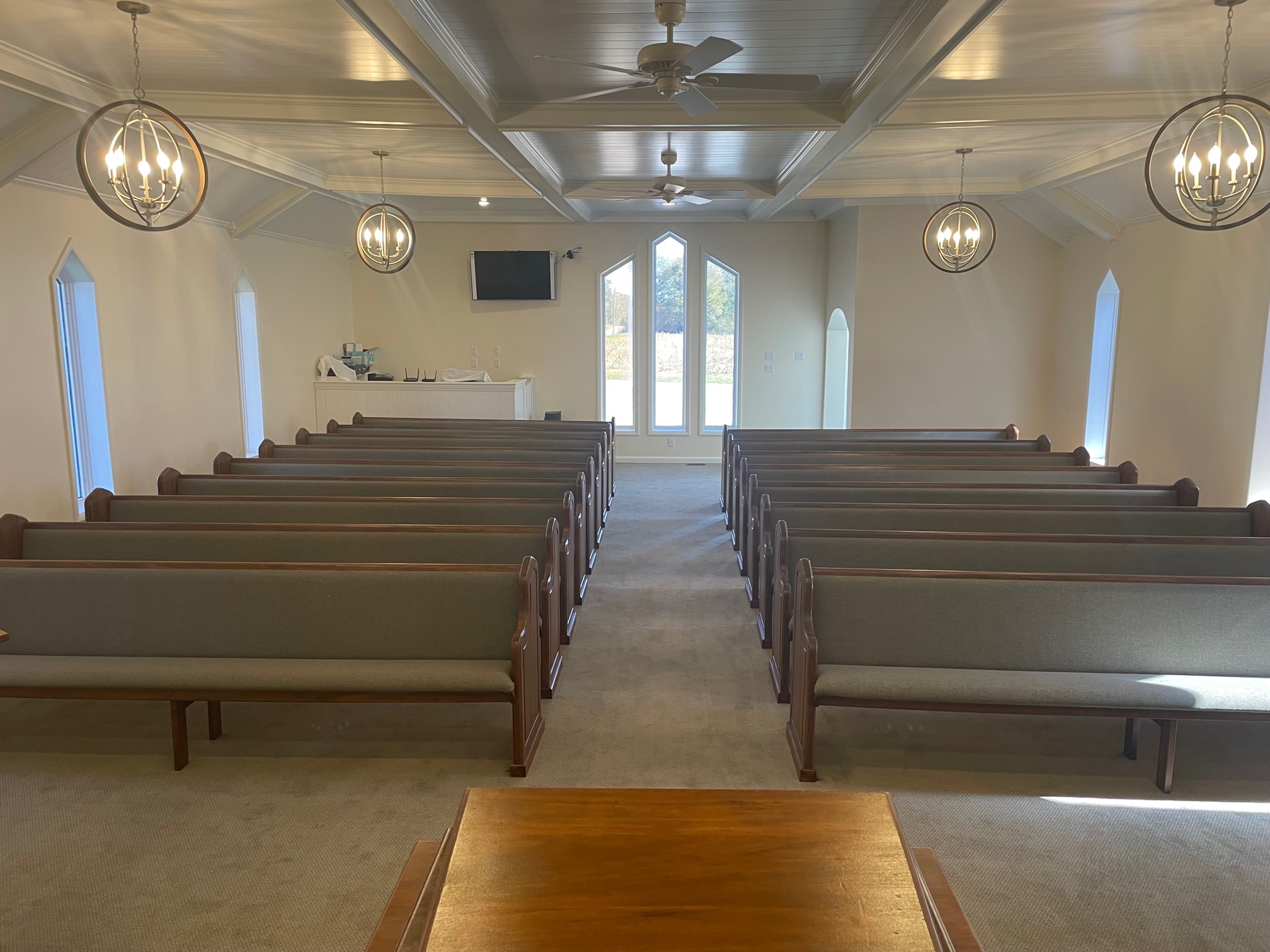 view from the front of Solid Maple Pews refinished at Hellerman Baptist in Grand Chain, Illinois by Woods Church Interiors
