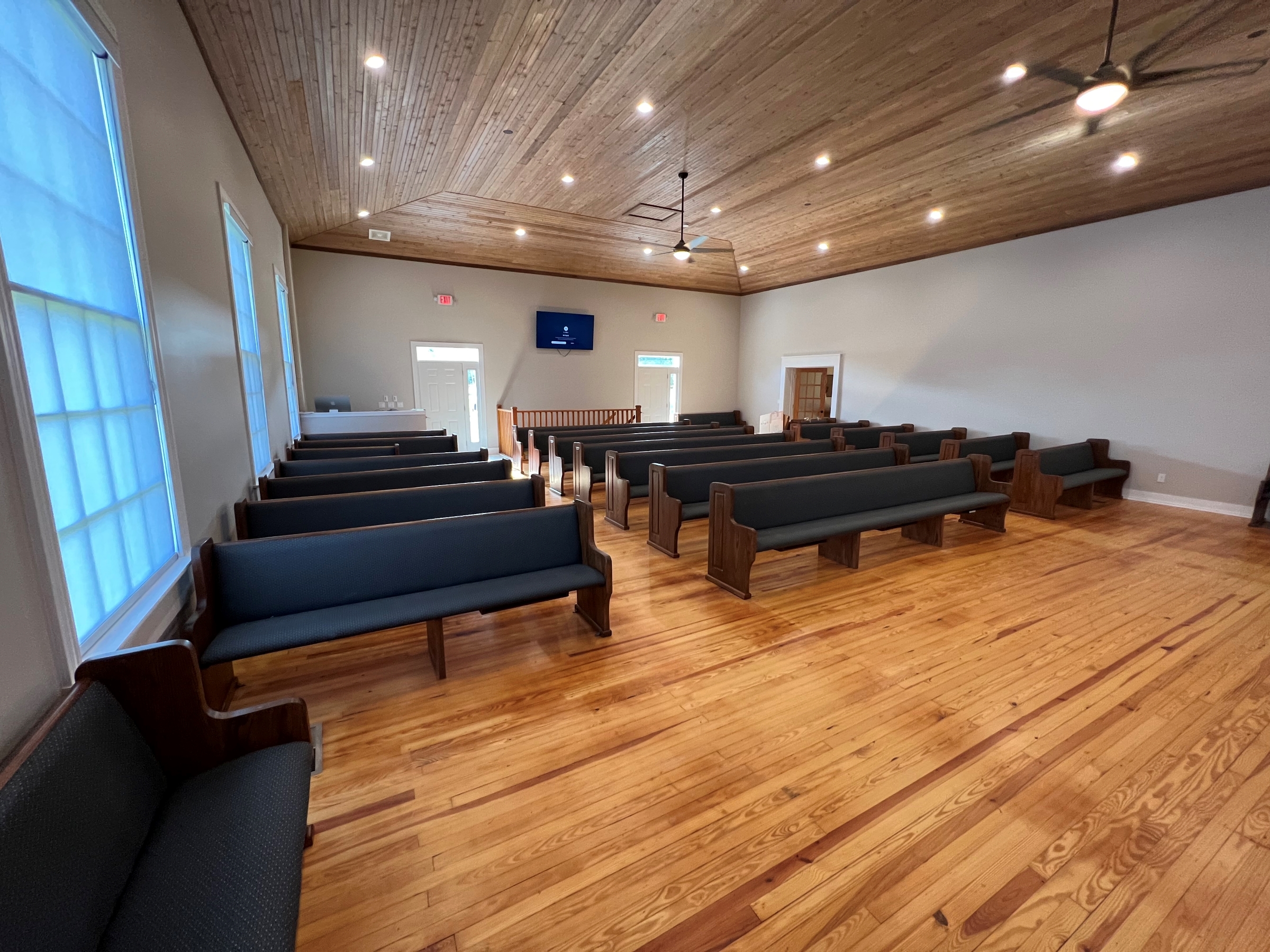 corner view of Pews refinished after tornado destroyed Hopewell Church in Canmer, Kentucky. Work by Woods Church Interiors
