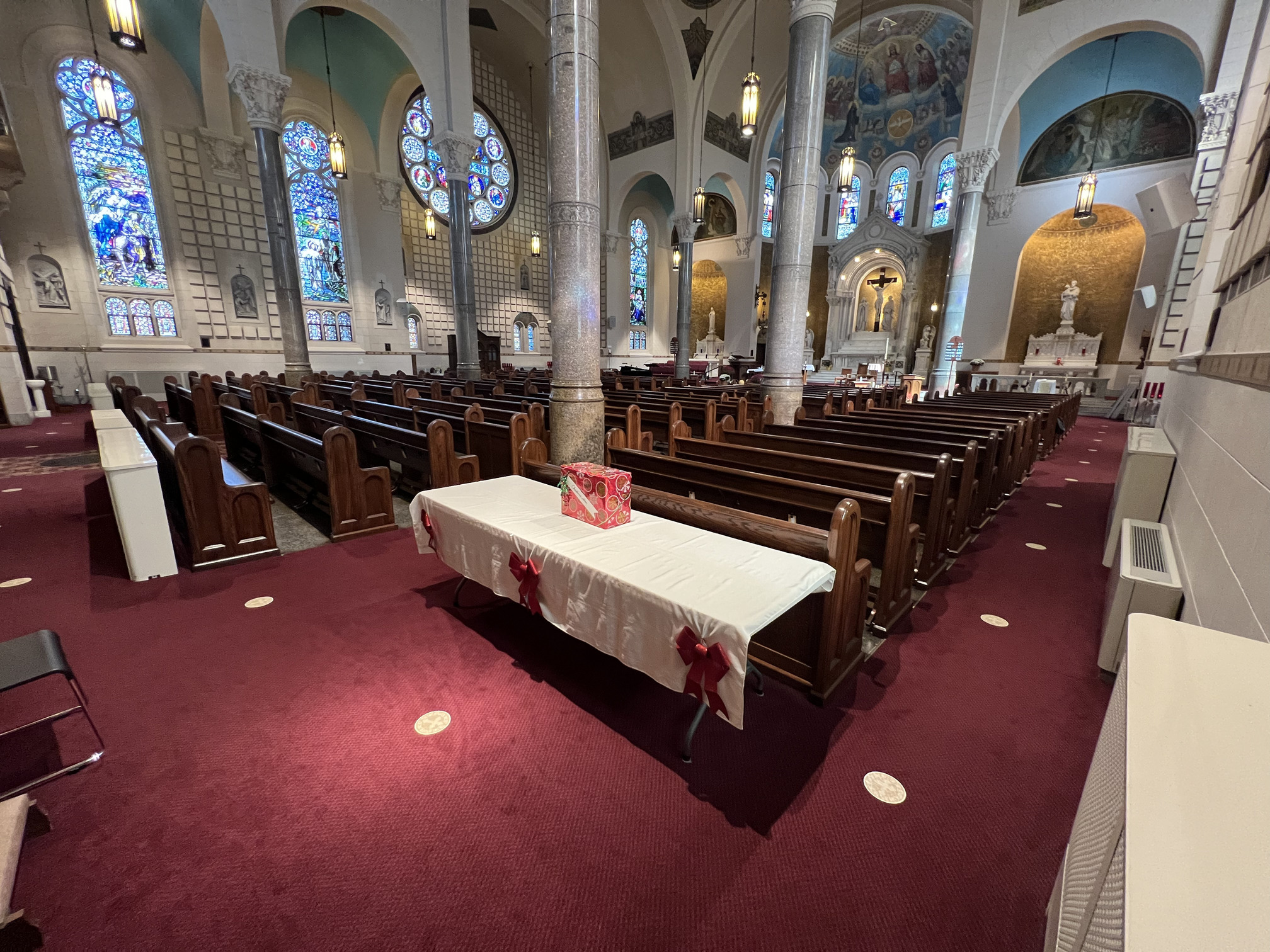 rear corner view 2 of the pews at St. Benedict Catholic in Terre Haute after being refinished by Woods Church Interiors