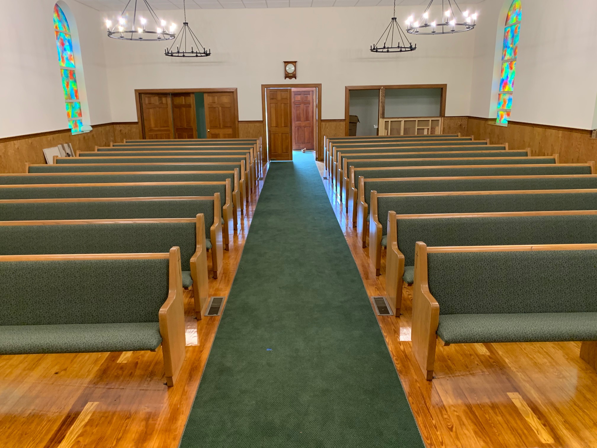 center front view of the newly refinished pews at Lumber City Baptist in Lumber City, Georgia. Refinish and reupholstery by Woods Church Interiors