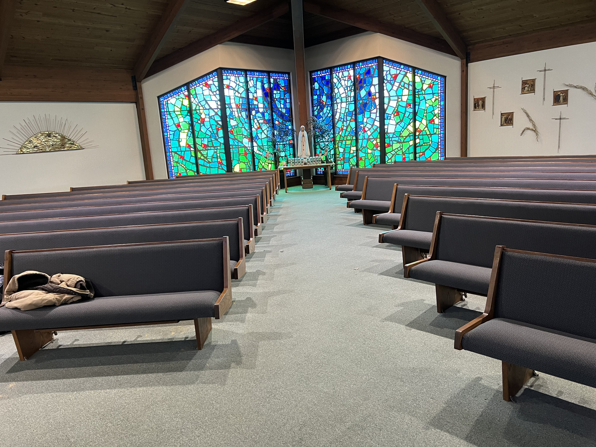 Right aisle view of church pew upholstery Roscommon Michigan performed by Woods Church Interiors nationwide pew upholstery service